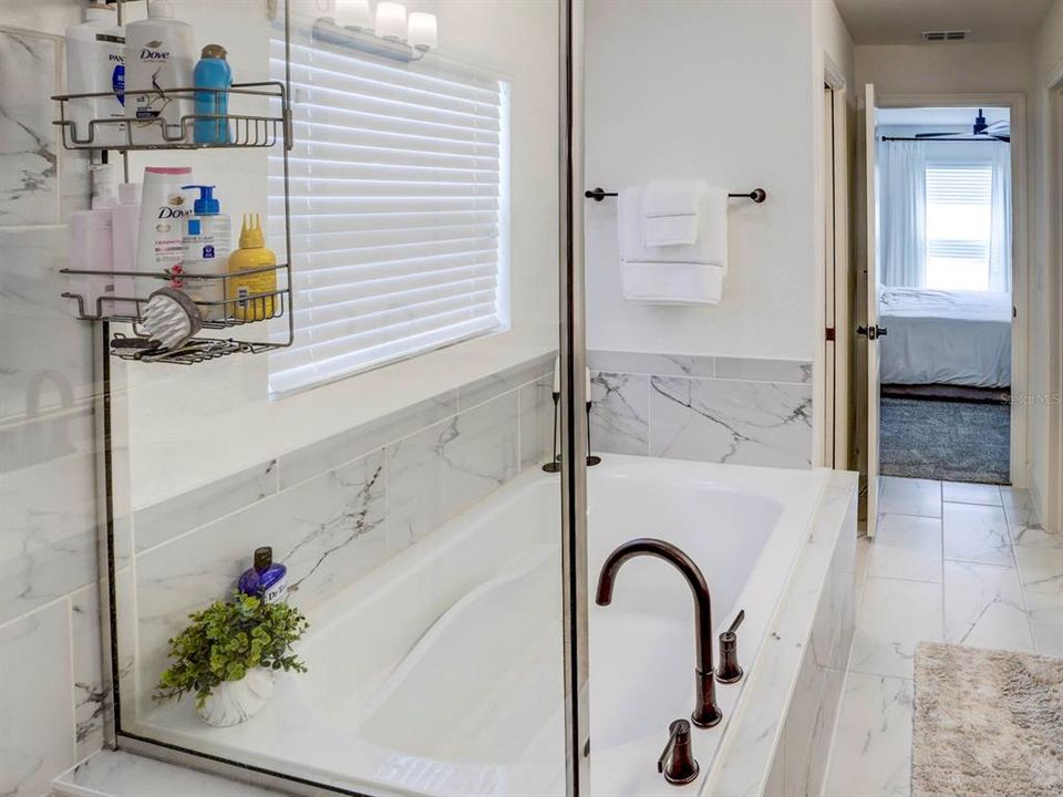 Master/Primary tub bath with view of the bedroom.