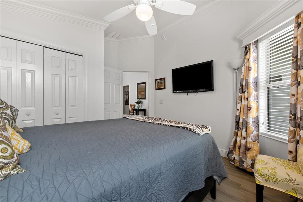 Bedroom 2 - perfect for guests at front of home with king bed, wall-mounted 48" TV, and double closet space.