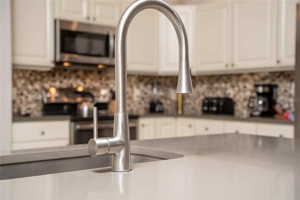 Beautiful quartz counters and granite backsplash