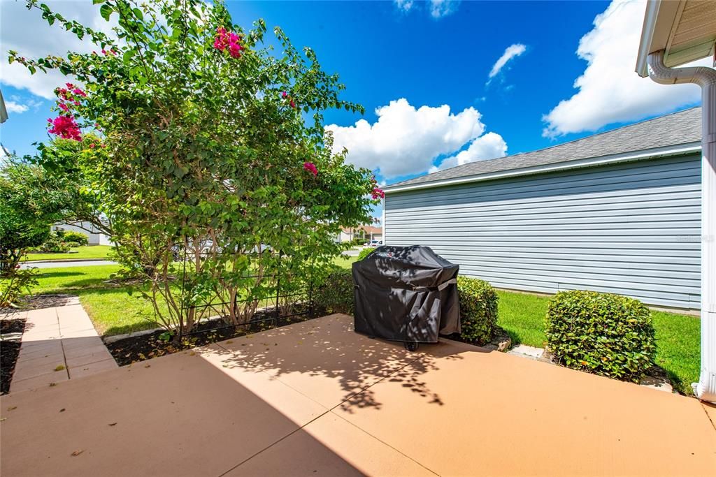 Outdoor patio area with Weber grill and cover included.