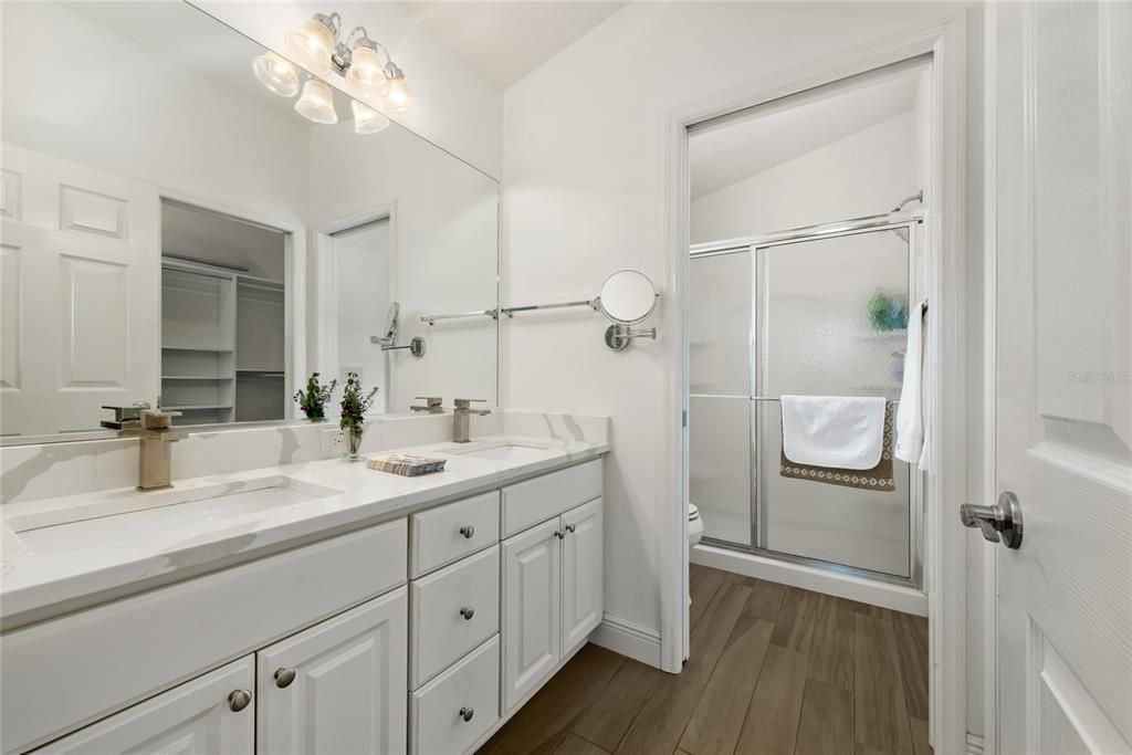 Primary Bedroom Ensuite bathroom with dual sinks and beautiful quartz countertop.