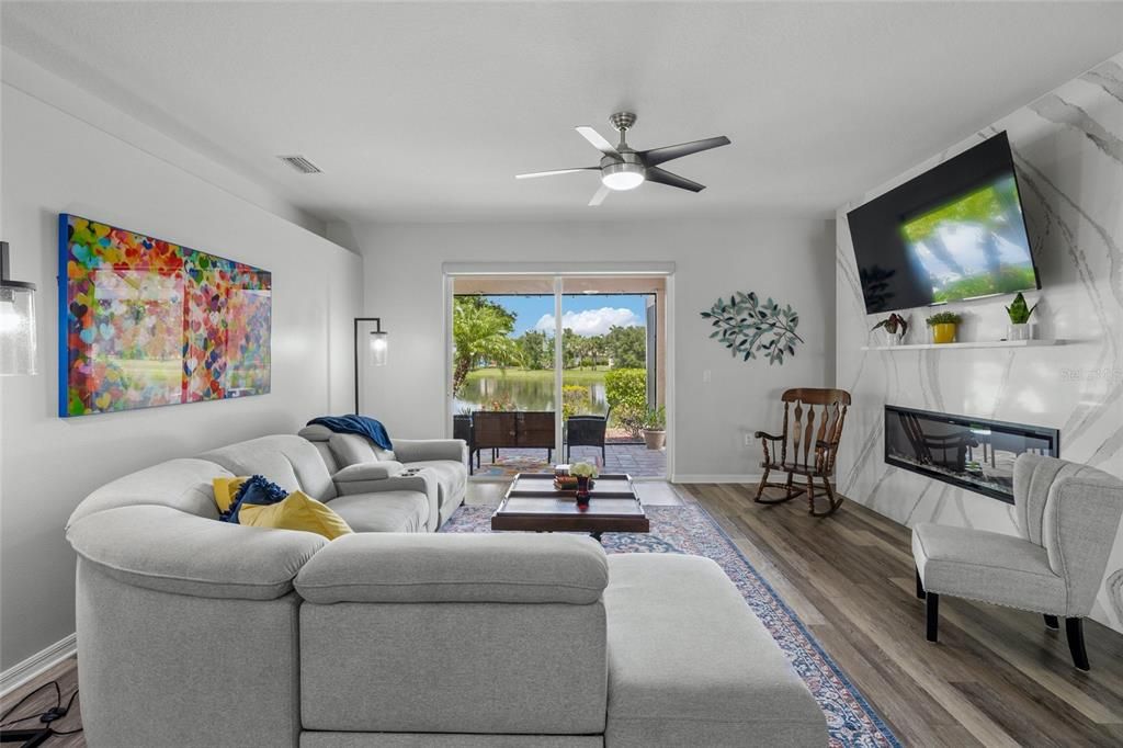 Family room with quartz design fireplace. Watch your favorite TV show and enjoy the lighted fireplace