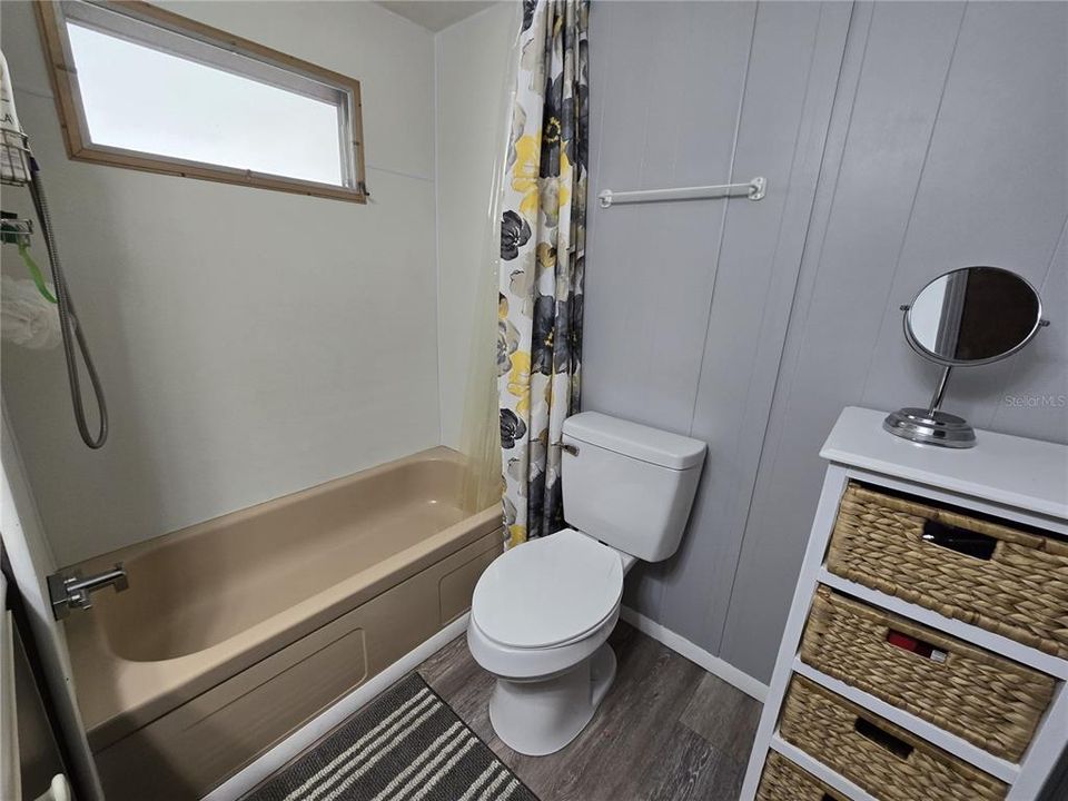 Primary bathroom tub with shower