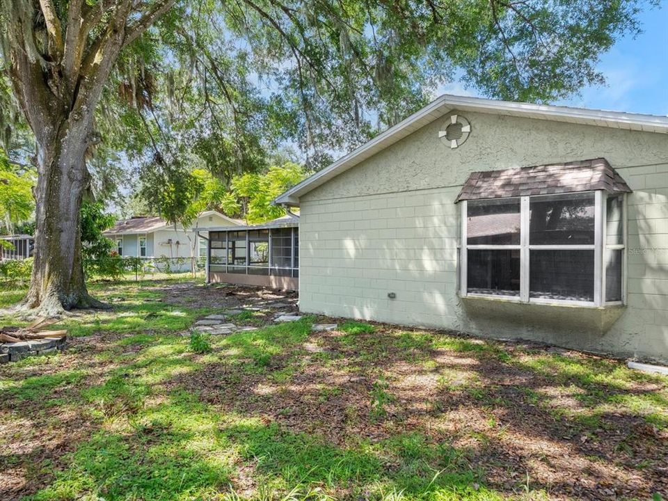 Fully fenced backyard with mature trees.