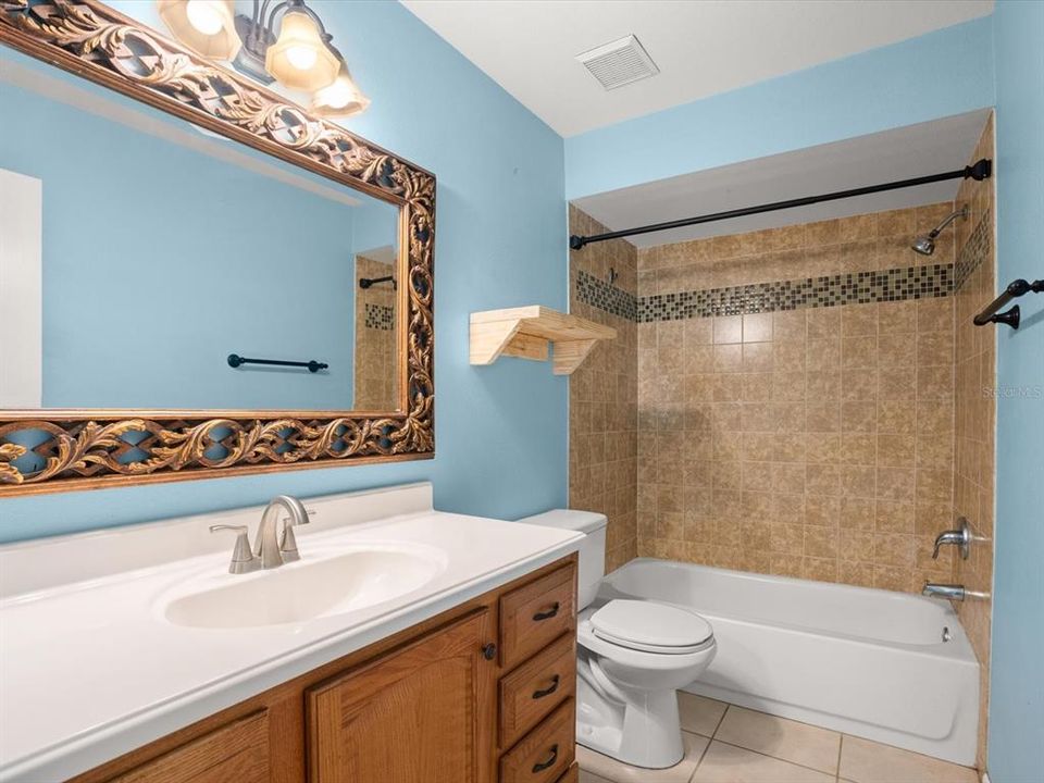 Bathroom two with beautiful, large vanity, mirror & lighting. Large bath/shower combo with updated shower tile.