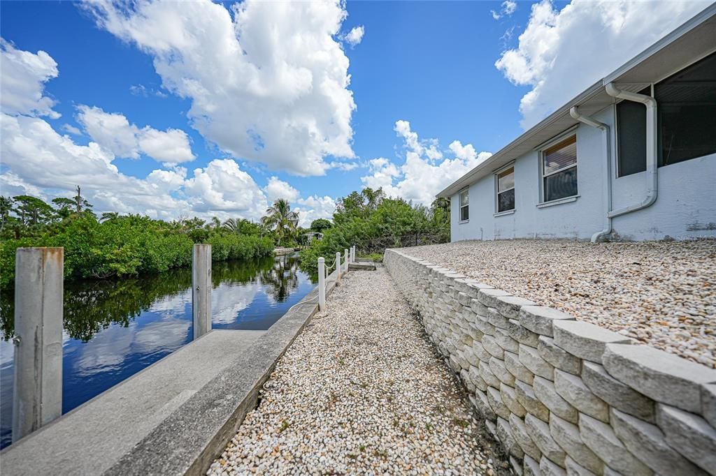 Rear of Home with Concrete Dock and Seawall.  120 Ft of Waterfront