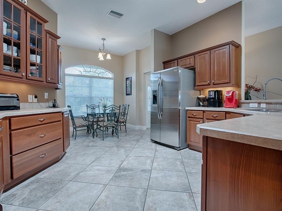 SPACIOUS KITCHEN WITH CHERRY CABINETS, UNDER CABINET LIGHTING, POT DRAWERS, AND SO MUCH MORE.