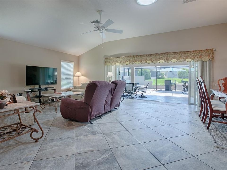 STACK BACK SLIDING GLASS DOORS OPENS THIS ENTIRE AREA OUT TO THE TILED LANAI AND EXPANDED BIRDCAGE AREA.