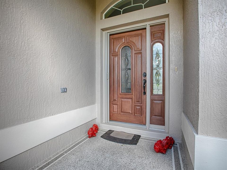 LEADED GLASS FRONT DOOR WITH POCKET SCREEN DOOR AND SIDELITE.