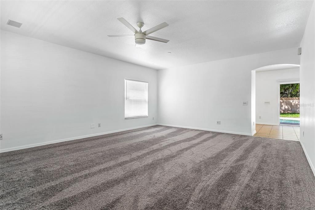 Upon entering through the front door into the large living space you'll see  brand new carpet and paint, fan/light, and faux wood blinds.