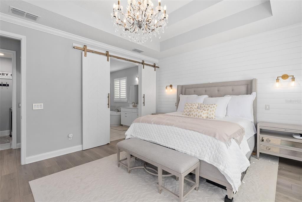 Primary bedroom with custom barn doors