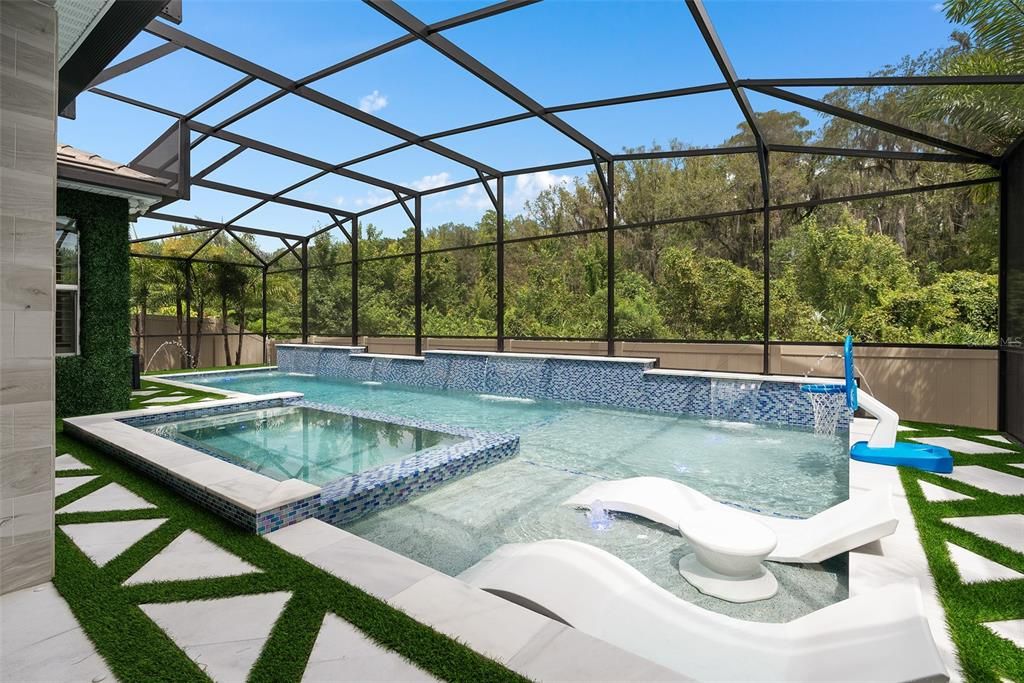 Resort-Style saltwater pool with glass mosaic tile throughout and sun shelves