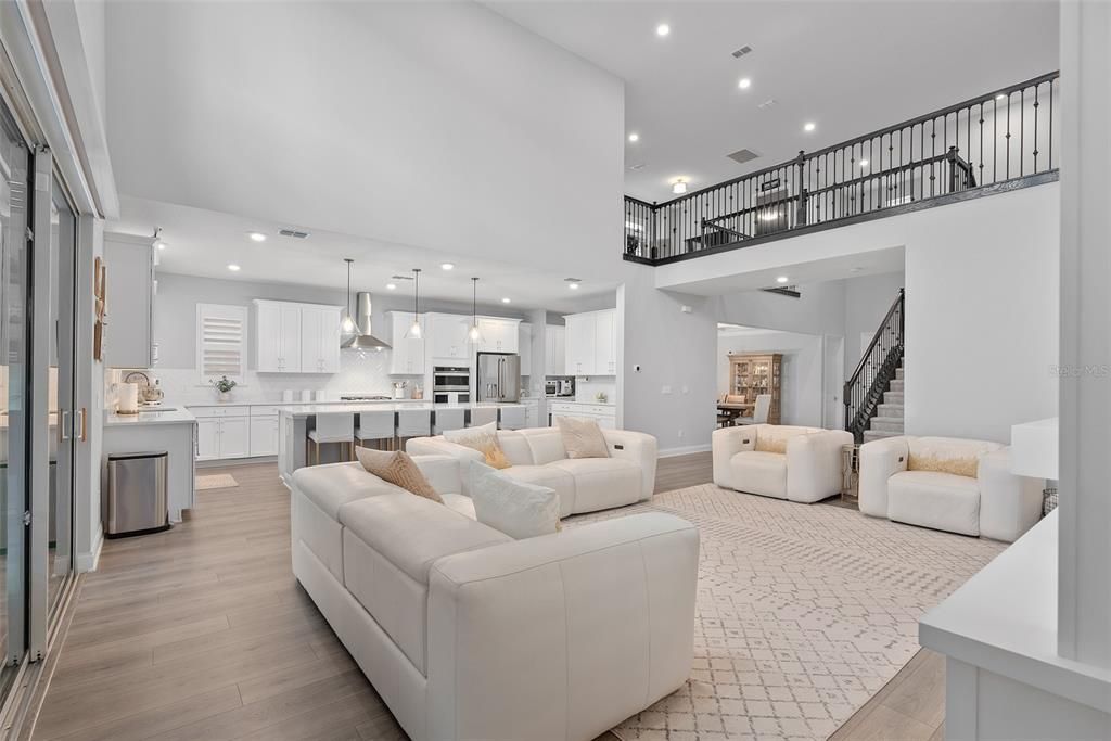 Living room/kitchen with grand ceilings