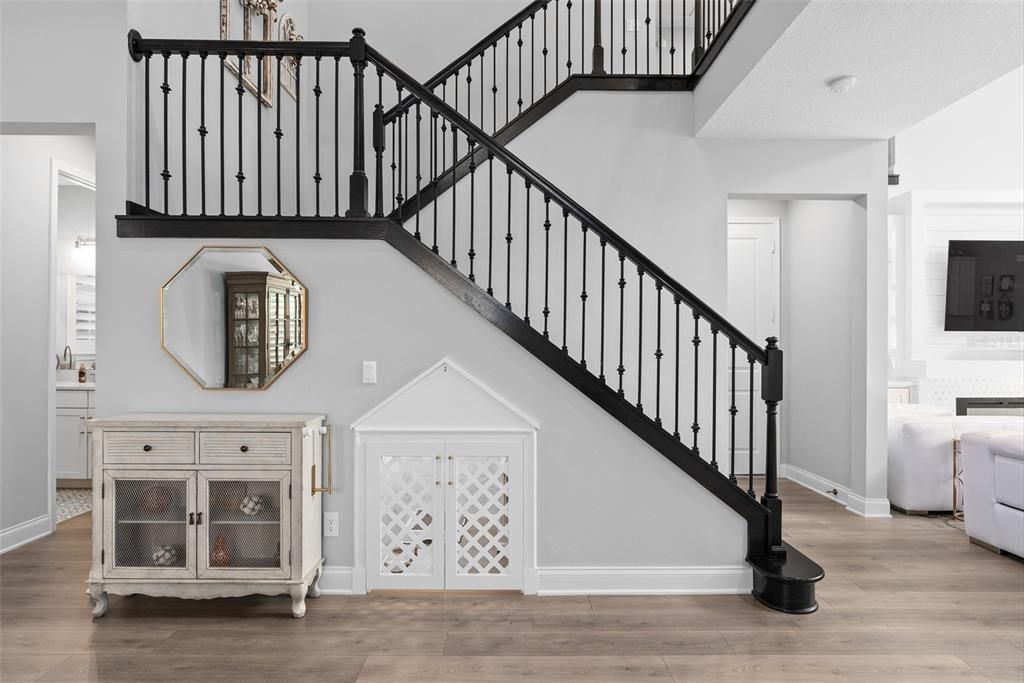 Stairwell with custom under stair built-in doghouse