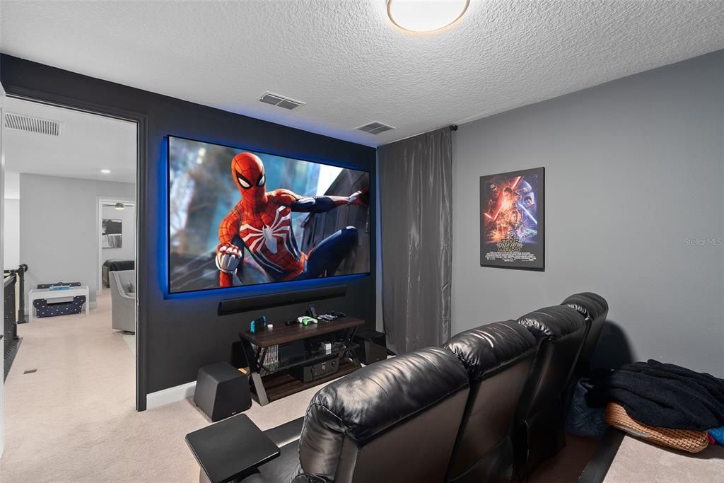 Dedicated home theater with 110" projection screen shown