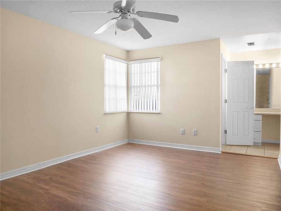 View into primary bedroom from entrance showing the vanity and windows.