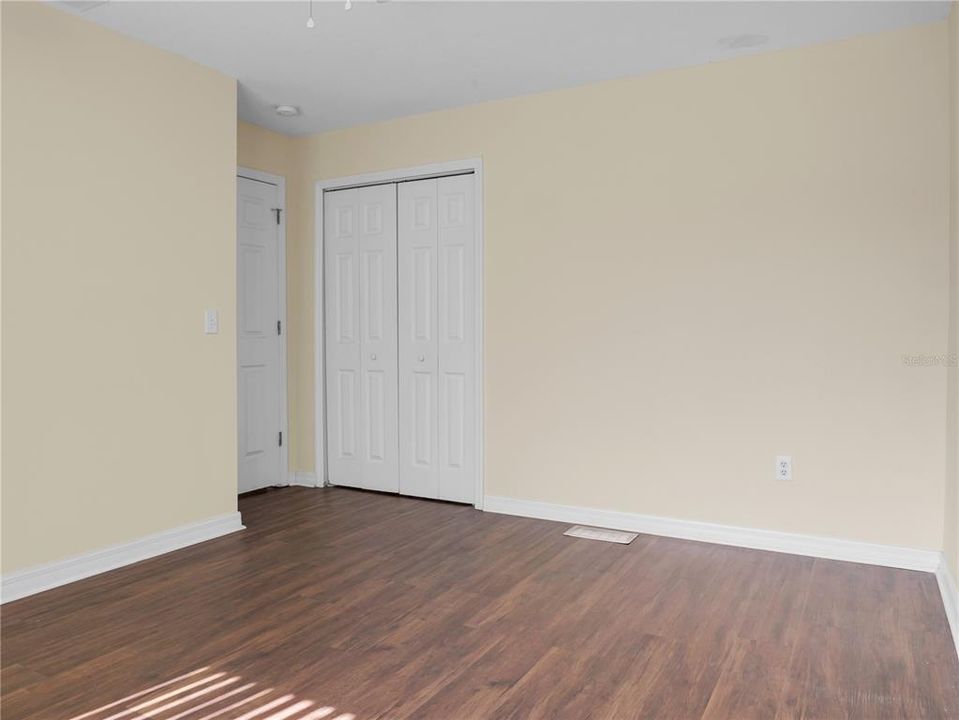 View inside bedroom 3 toward the entry and closet.