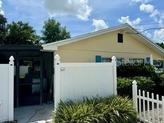 Back entry of house to screen porch and yard