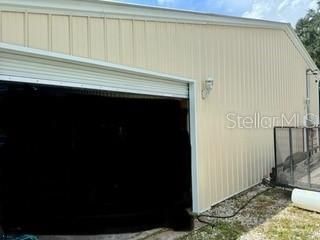 Back of garage with 1 of 3 roll up doors.