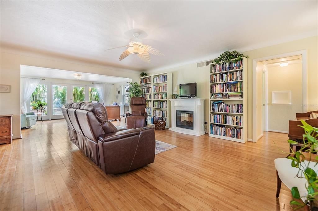 Enter through the front door into the open living room that flows into the sunroom. Many windows provide an abundance of natural lighting and picturesque views of the professionally landscaped yard.