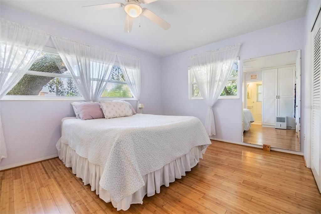 Primary bedroom at the front of the home with two large windows, a wall closet, two wardrobes and ensuite bathroom