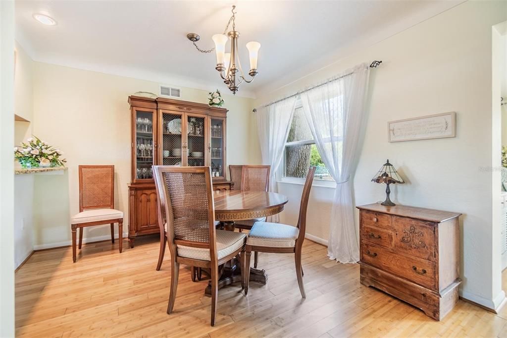 Dining room with raised countertop opening to kitchen to pull up stools and ideal serving area when entertaining guests