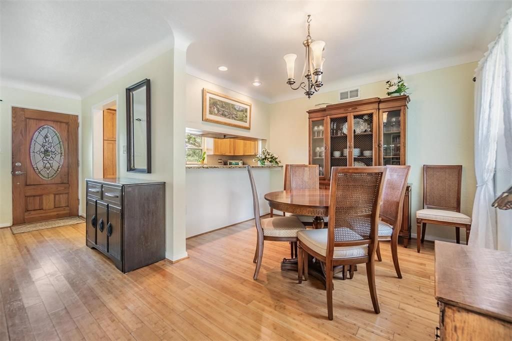 Dining room with raised countertop opening to kitchen to pull up stools and ideal serving area when entertaining guests