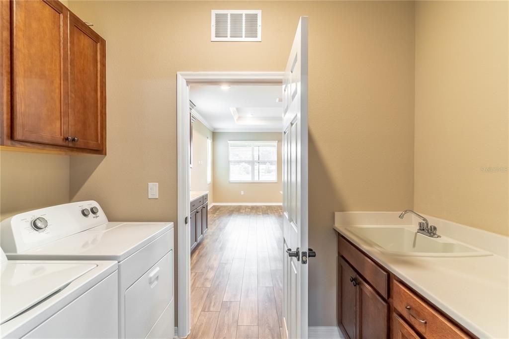 Washer & dryer included, laundry sink, extra cabinets.