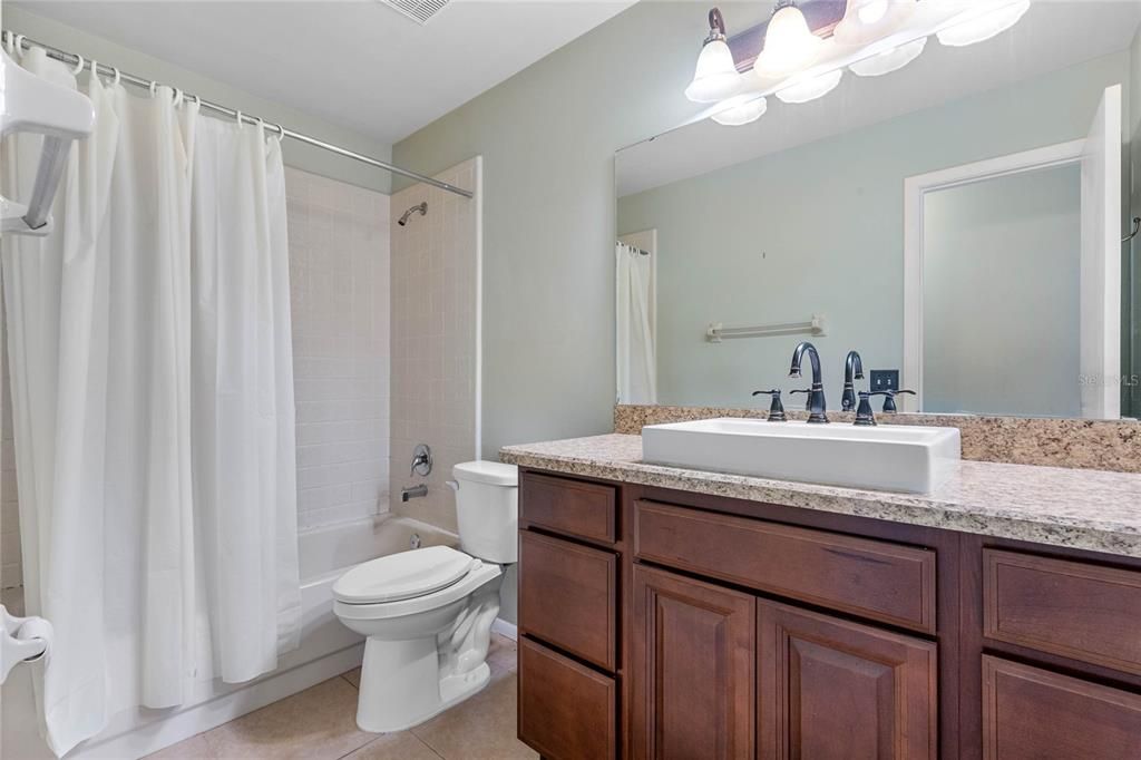 Second full bathroom with updated vanity and bathtub