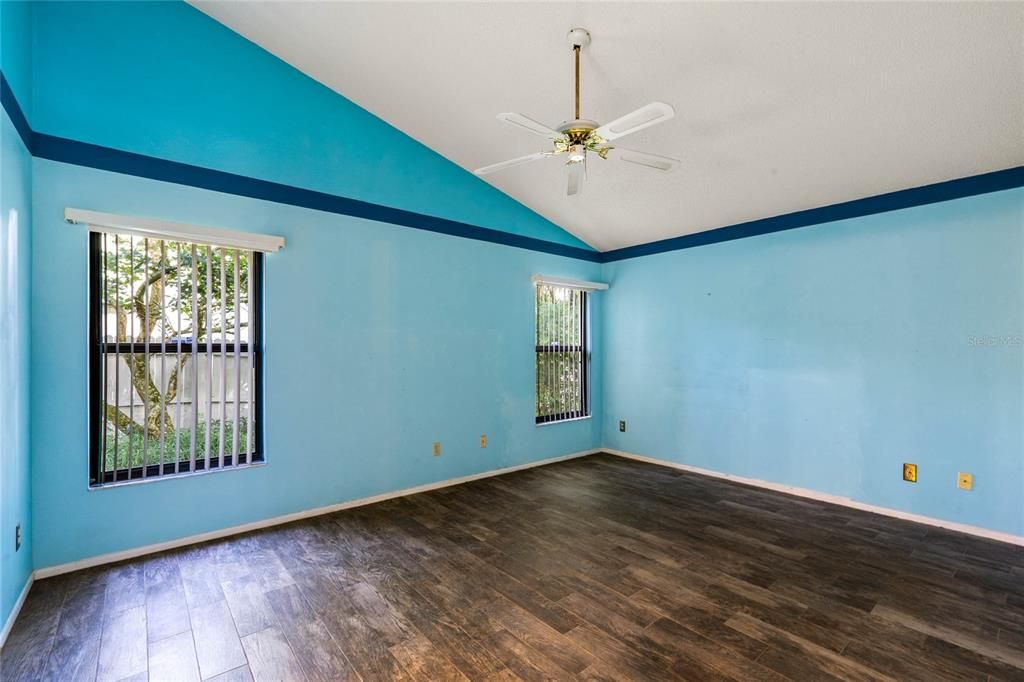 Primary bedroom with vaulted ceilings