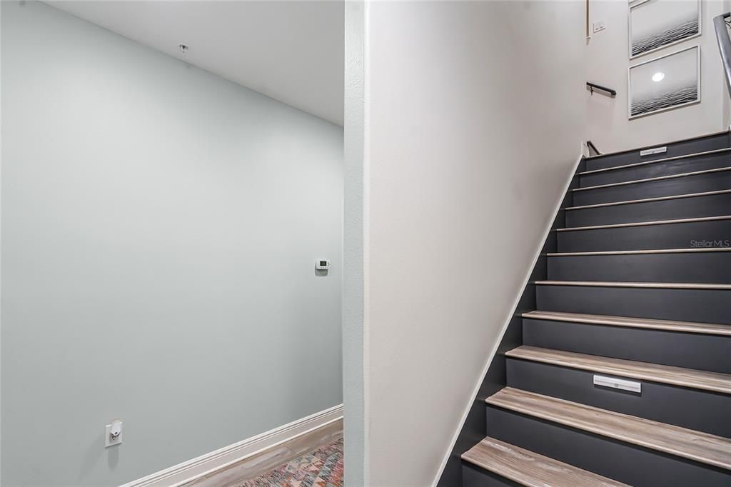 Stairs to second floor with luxury vinyl plank flooring