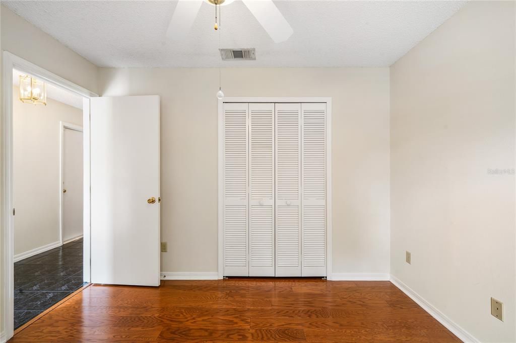 Second guest bedroom has engineered hardwood oak flooring, ceiling fan and bi-fold closet.