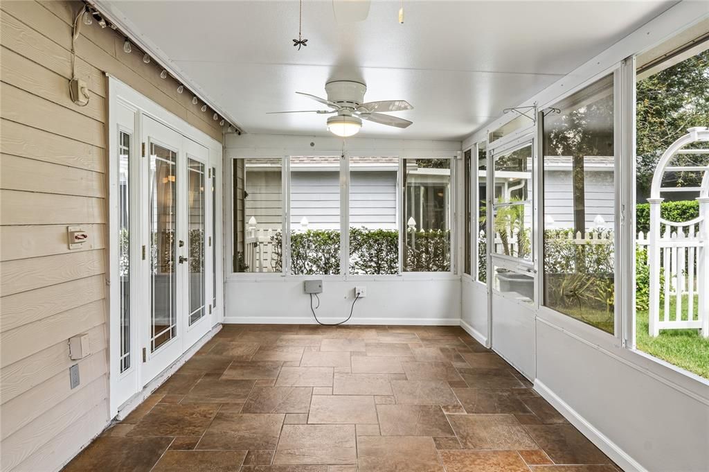 Tile floors, ceiling fans and bistro lighting make this a multi-purpose room.