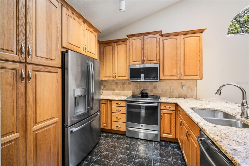 Nicely appointed kitchen with Stainless Steel GE appliances, including French Door refrigerator, dishwasher, microwave and slide-in oven/range