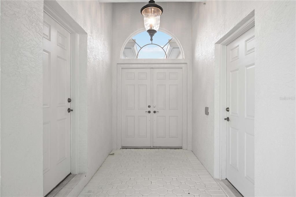 Courtyard entry. Door on the right leads into the garage. Door on the left leads into the casita. Chandelier operative via remote.