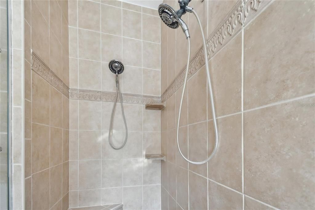 Primary bathroom shower with multiple shower heads