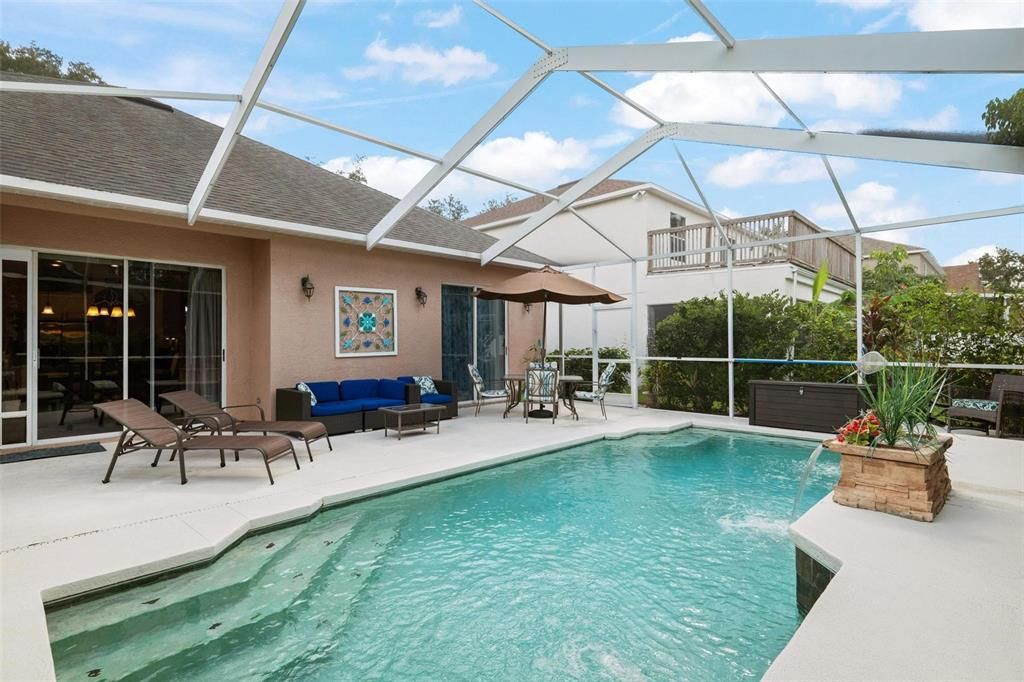 Plenty of entertaining room and stairs that go into the pool for relaxing by the pool if you don't want to take a full dip.