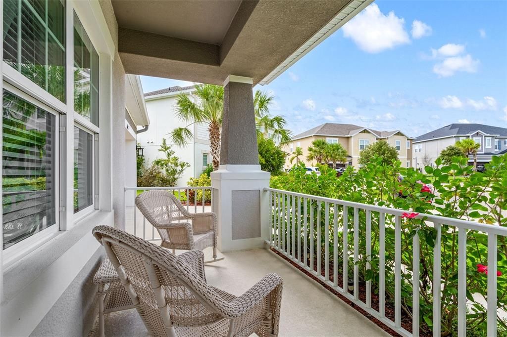 The porch welcomes you with this seating area.