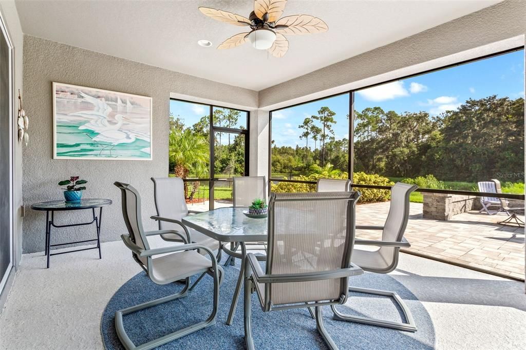 Extended screened lanai with outdoor entertainment area and plumbing for outdoor kitchen.