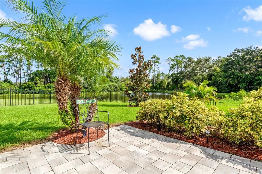 Walk out to your backyard with expansive paver patio.