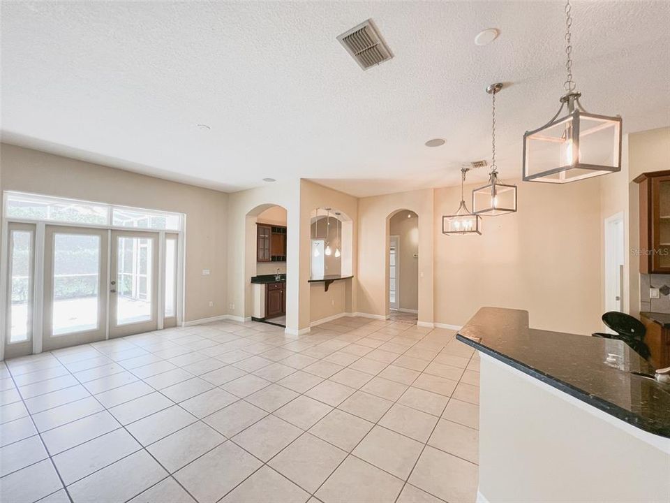 Patio access from the family room, a bar, garage and laundry room on the left.