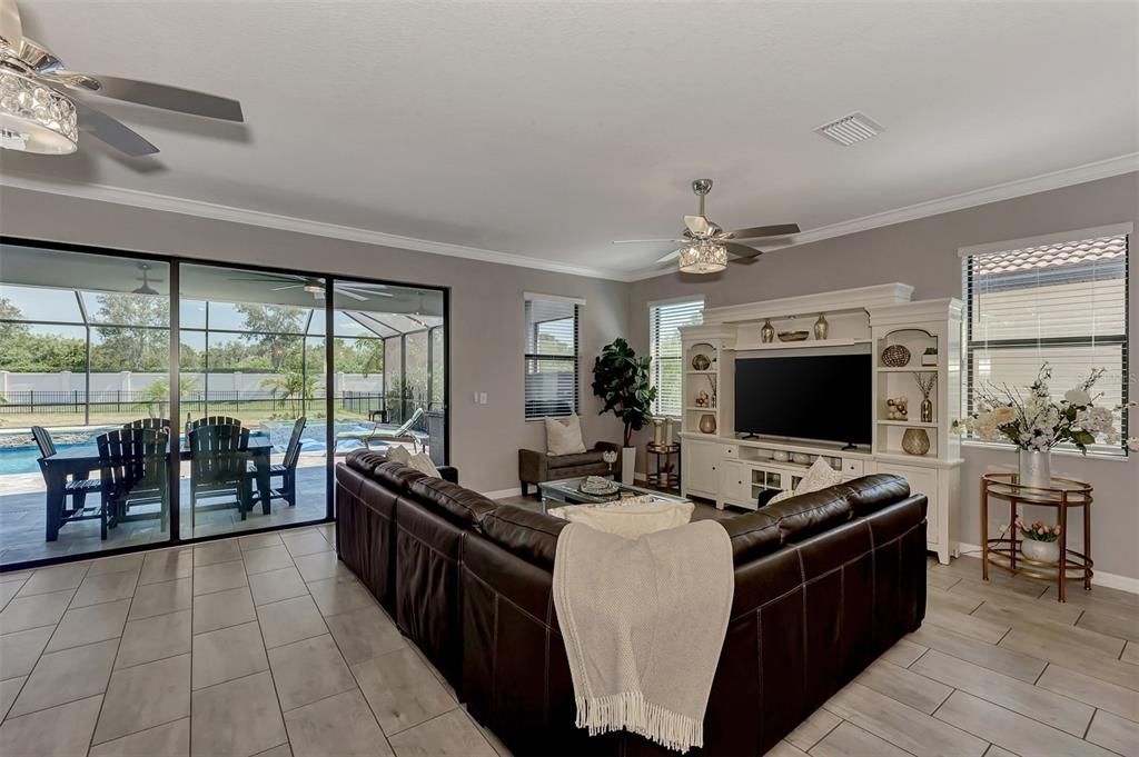 Relax in your LARGE living room while you enjoy the stunning natural light and view of your CUSTOM POOL!