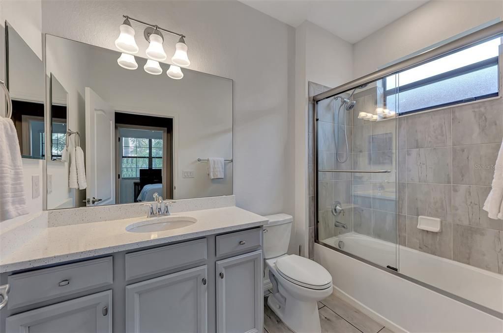 3rd bathroom with custom fit glass enclosure over the tub.