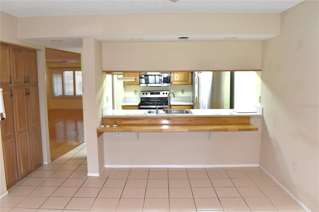 Passthrough from kitchen to den with tile floor