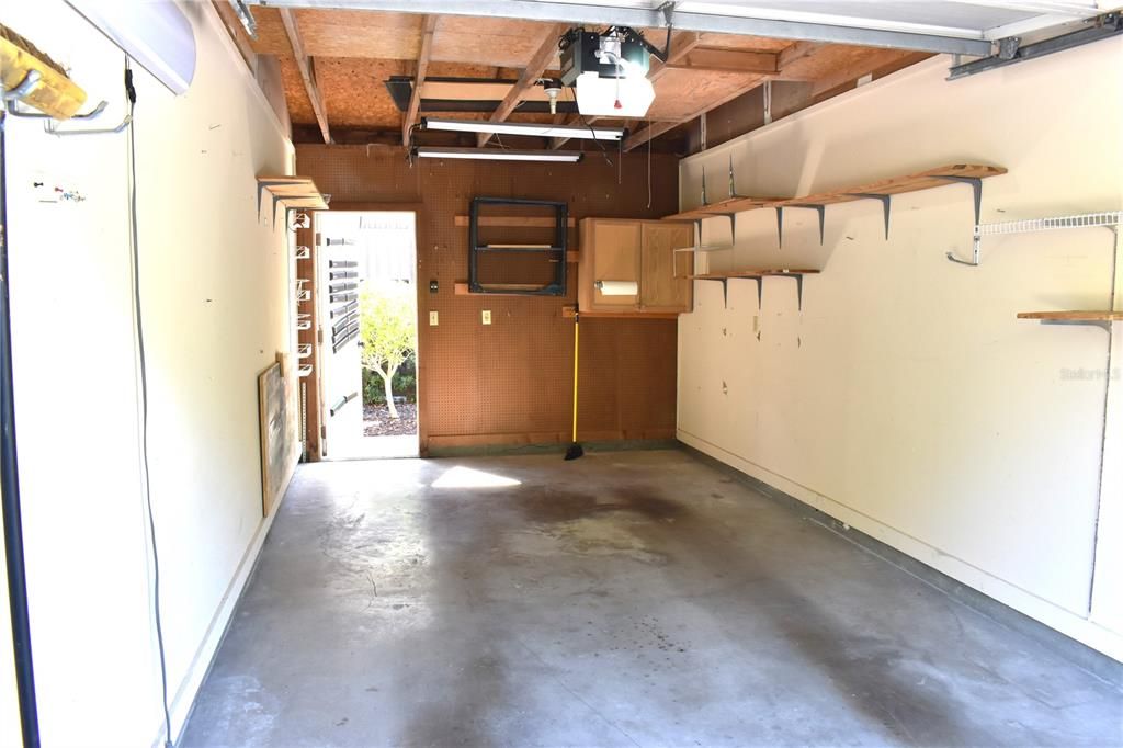 Inside garage & exit door & pull down steps to storage