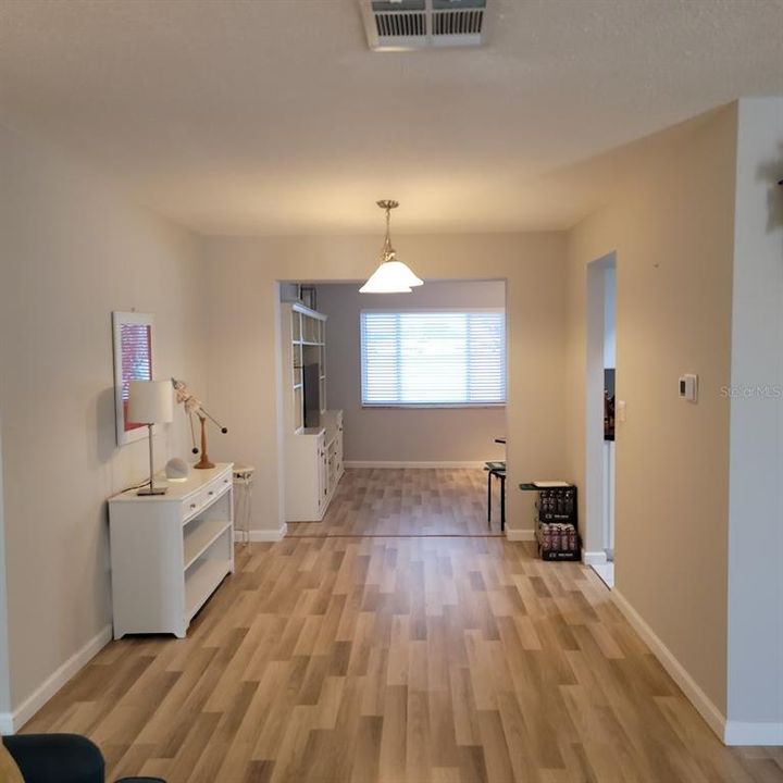 This area from the living room to the back Florida Room is sometimes used as a dining area. The door that leads to the kitchen is to the right.