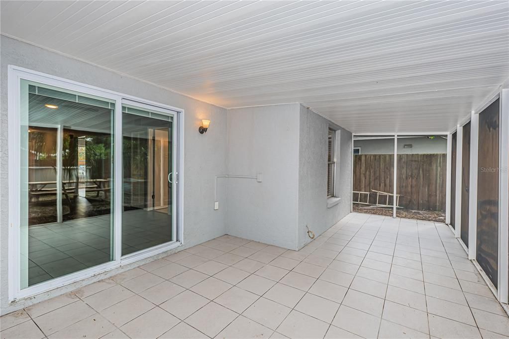 View of the sliding glass door giving entry to the screened patio from the house