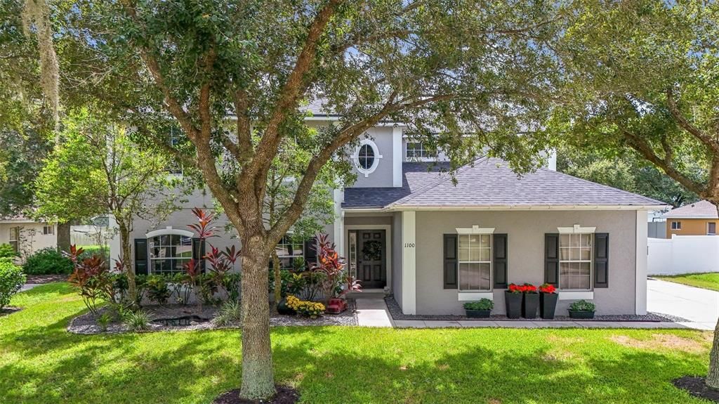 Lovely curb appeal with large, mature trees.