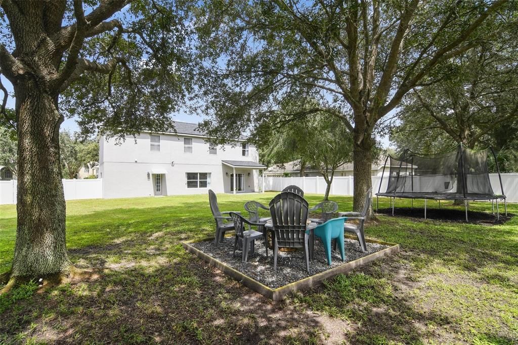 Fire Pit and trampoline convey with home. Large, mature trees provide wonderful shade.