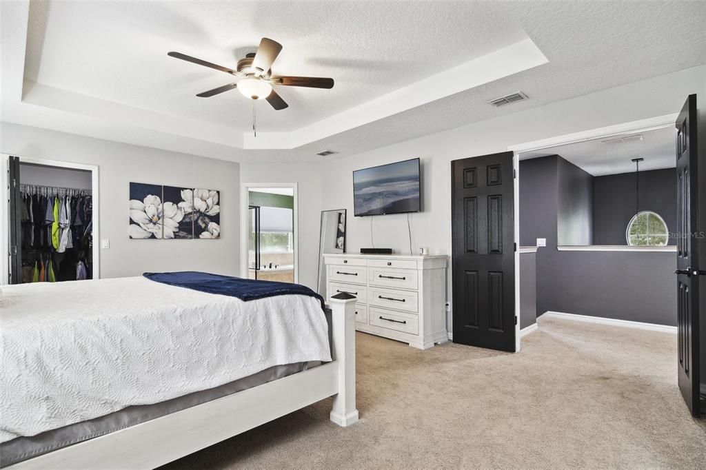 Primary Bedroom with view of Primary Bath to the left and Entry from Bonus Room. Large walk-in Closet on far left.